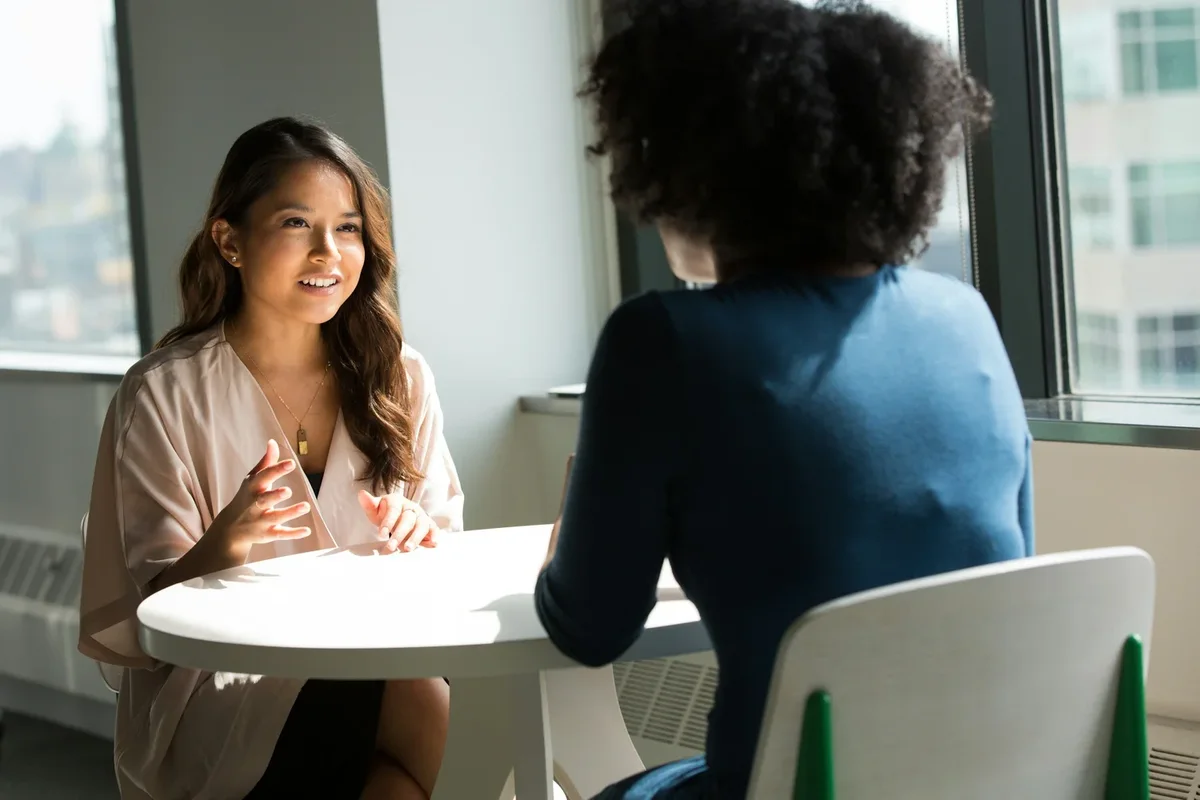 Two professionals discussing sales and use tax across a table